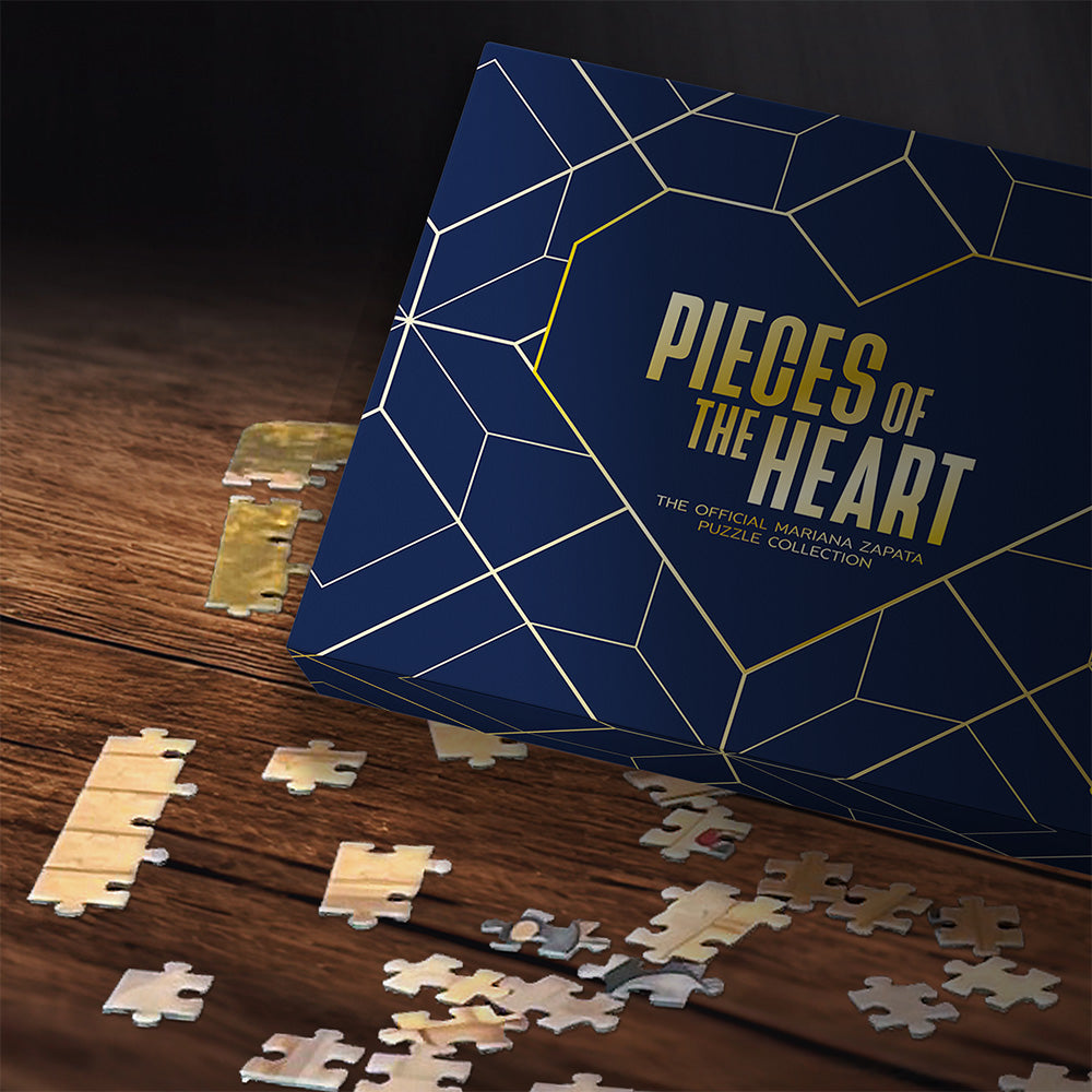 Puzzle box titled 'Pieces of the Heart' with puzzle pieces on a wooden surface